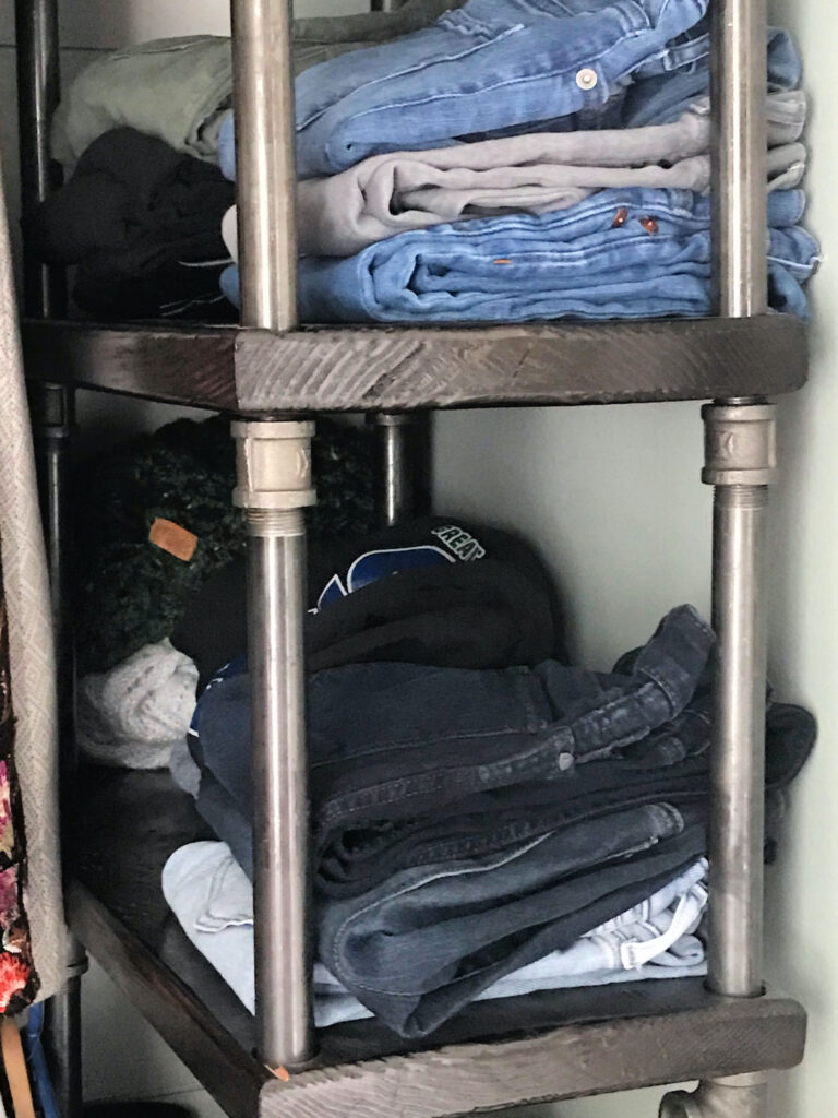 jeans on industrial closet shelves