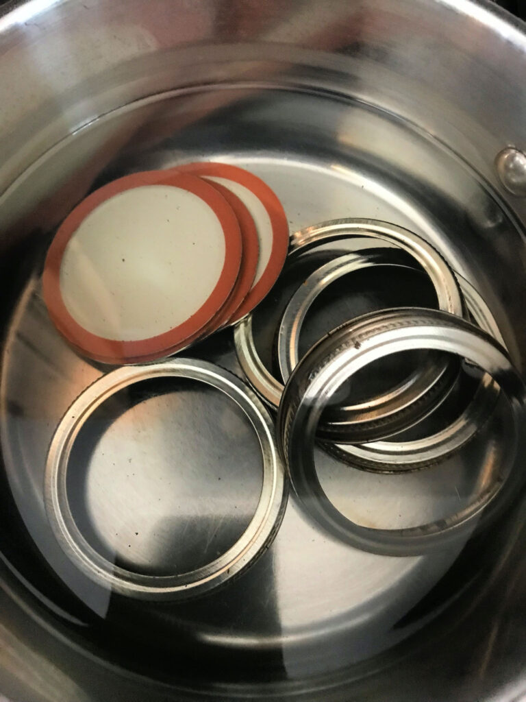 canning lids and bands in a saucepan