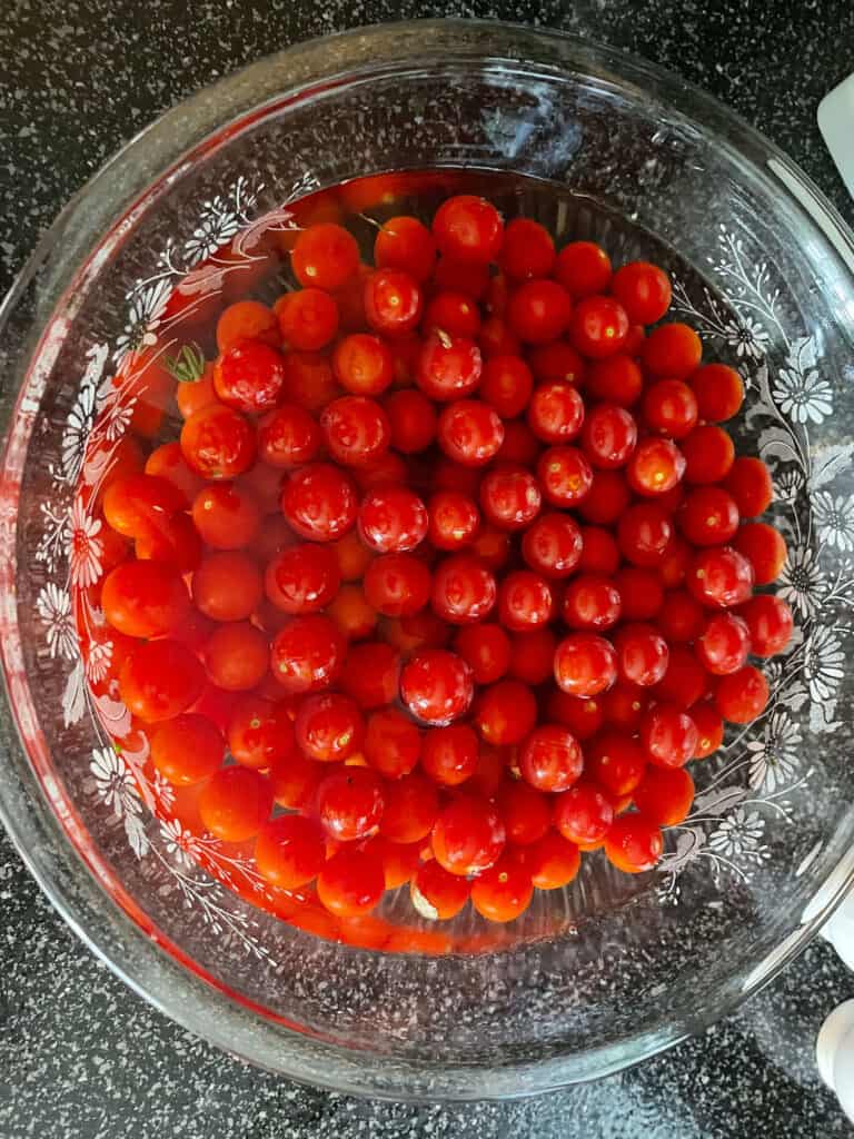 cherry tomatoes in white vinegar bath