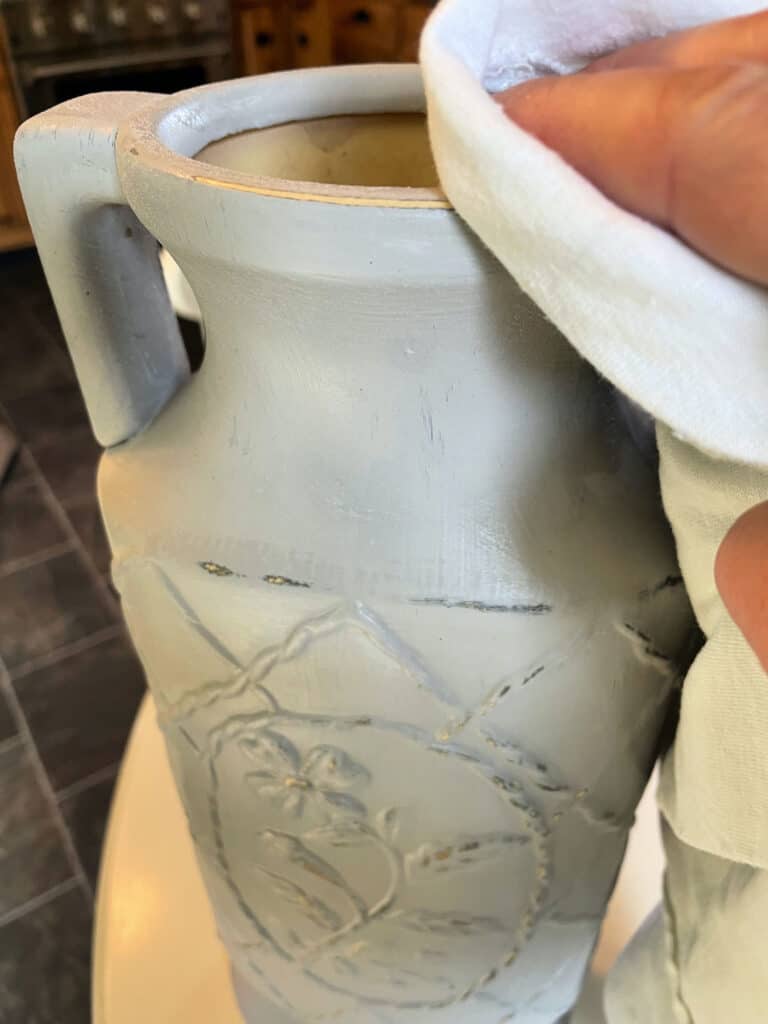 buffing a vase with a cloth